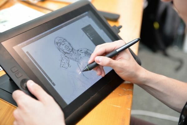Digital artist drawing a 2D image on a drawing tablet